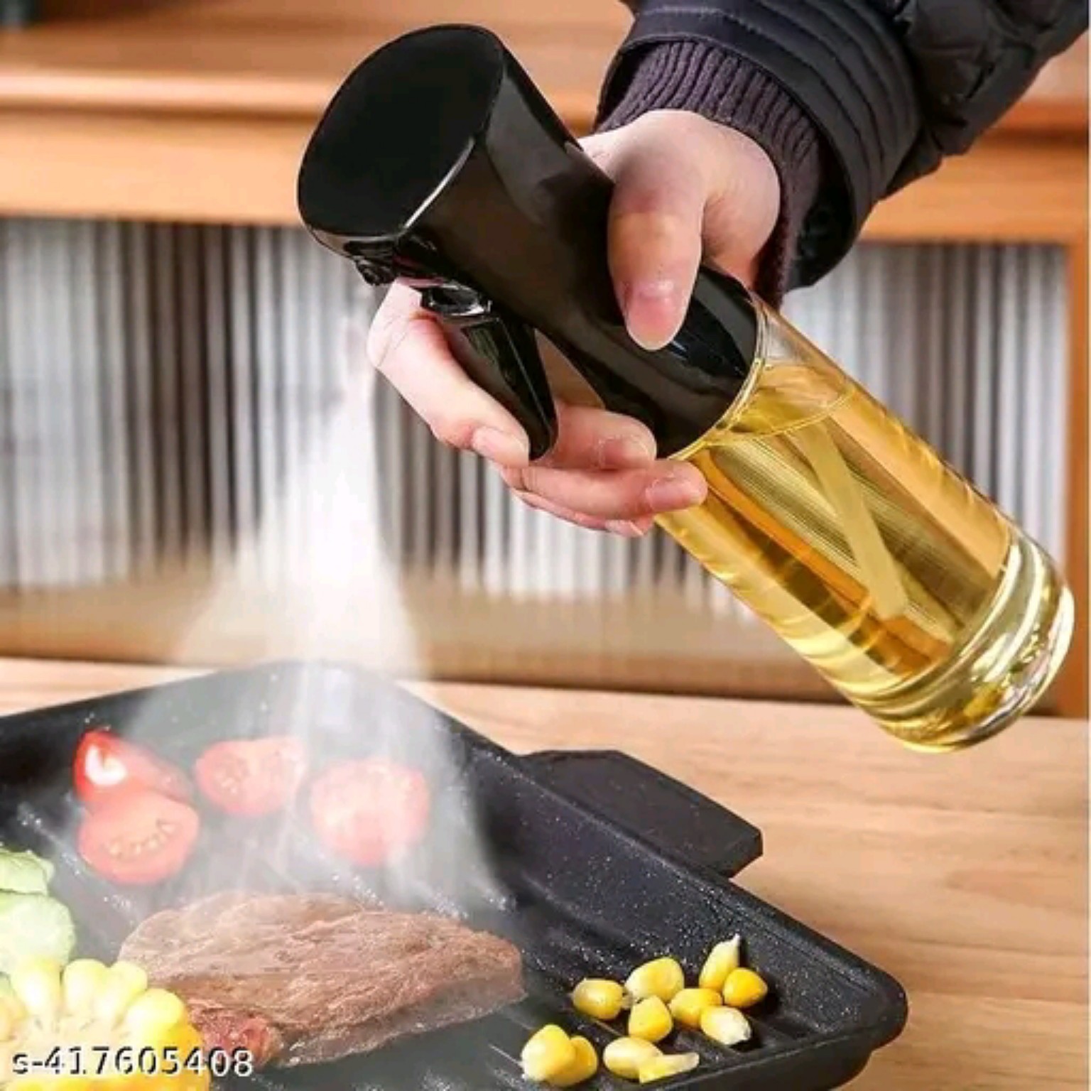 Oil spray bottle being used over food on a hot cooking surface