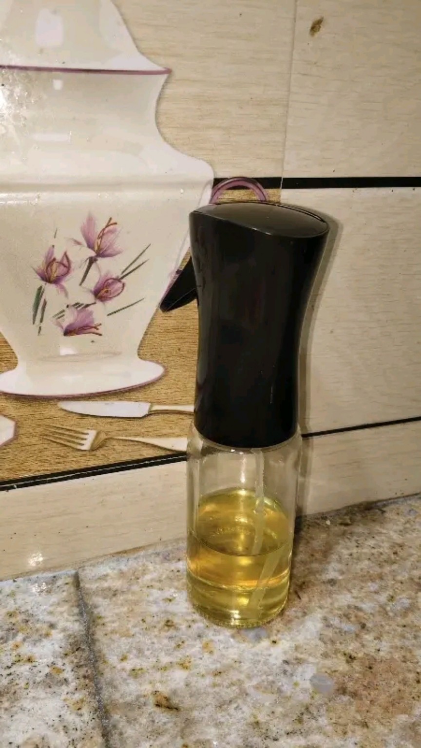 Oil Spray Glass Bottle standing on a kitchen counter